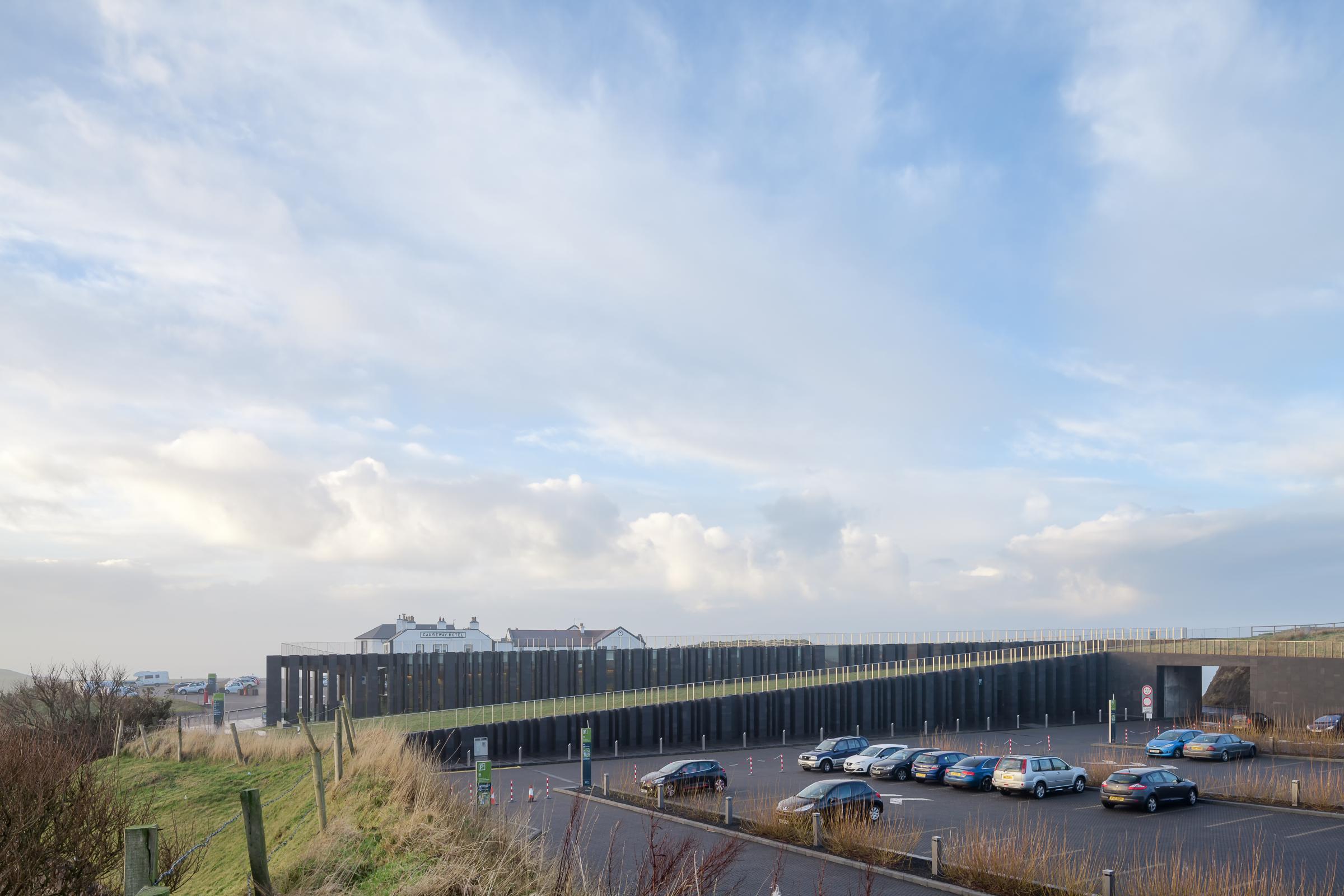 Photograph of Giants Causway Visitor Centre, designed by Heneghan Peng Architects and located in Bushmills, United Kingdom