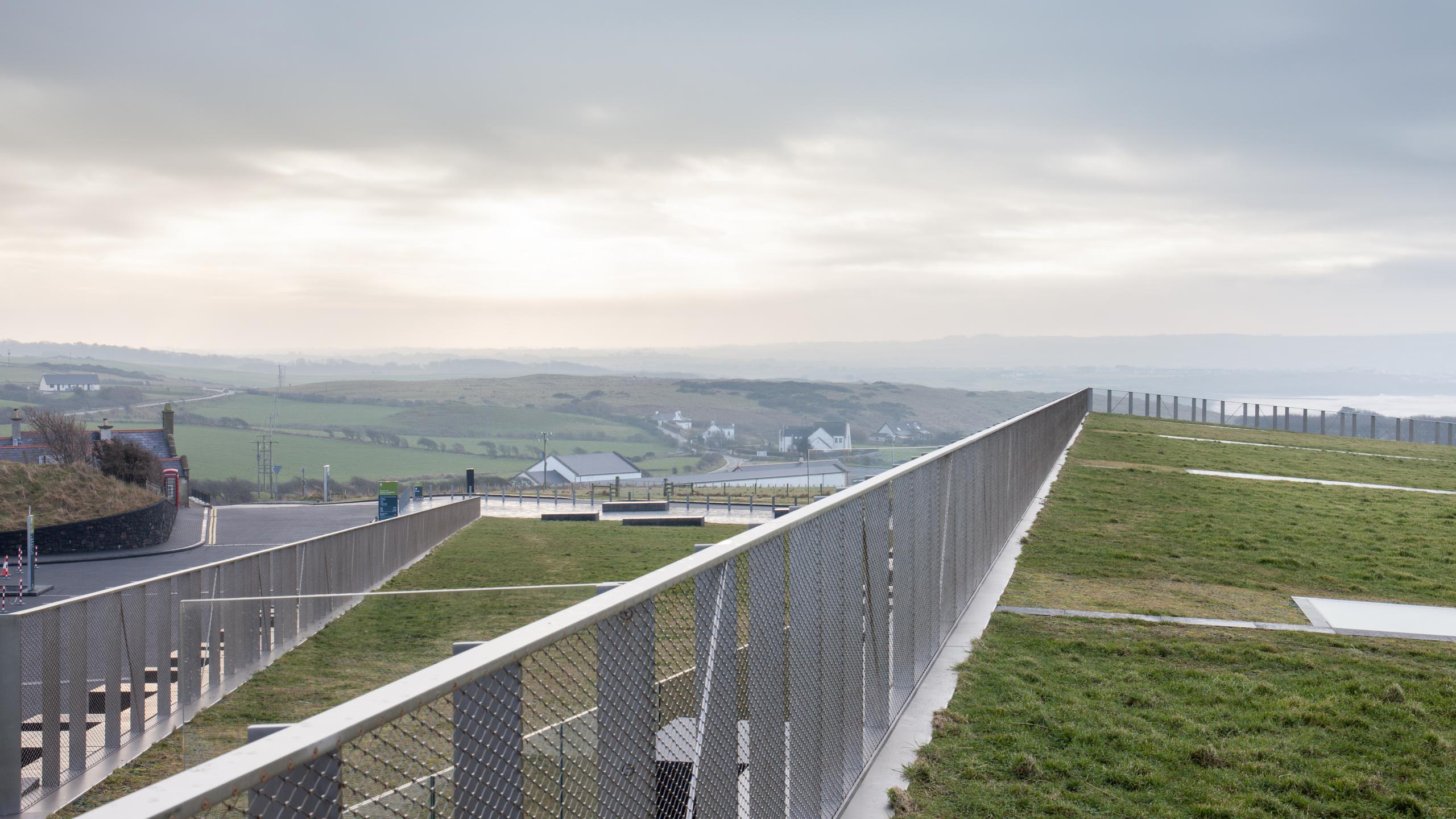 Photograph of Giants Causway Visitor Centre, designed by Heneghan Peng Architects and located in Bushmills, United Kingdom